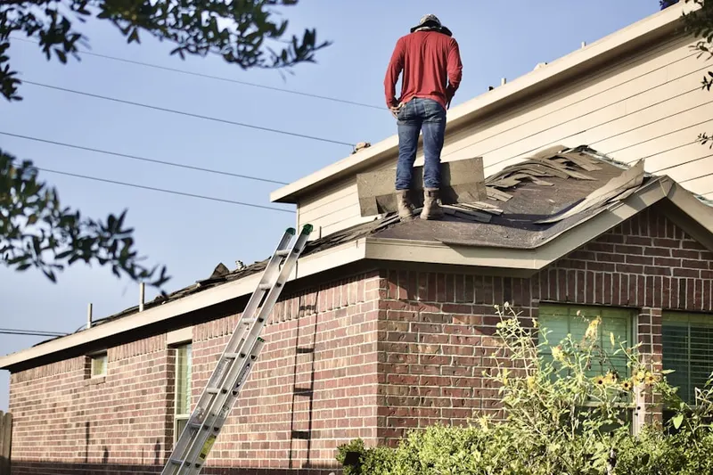 Professional roofer working on a residential roof in Oak View Homes